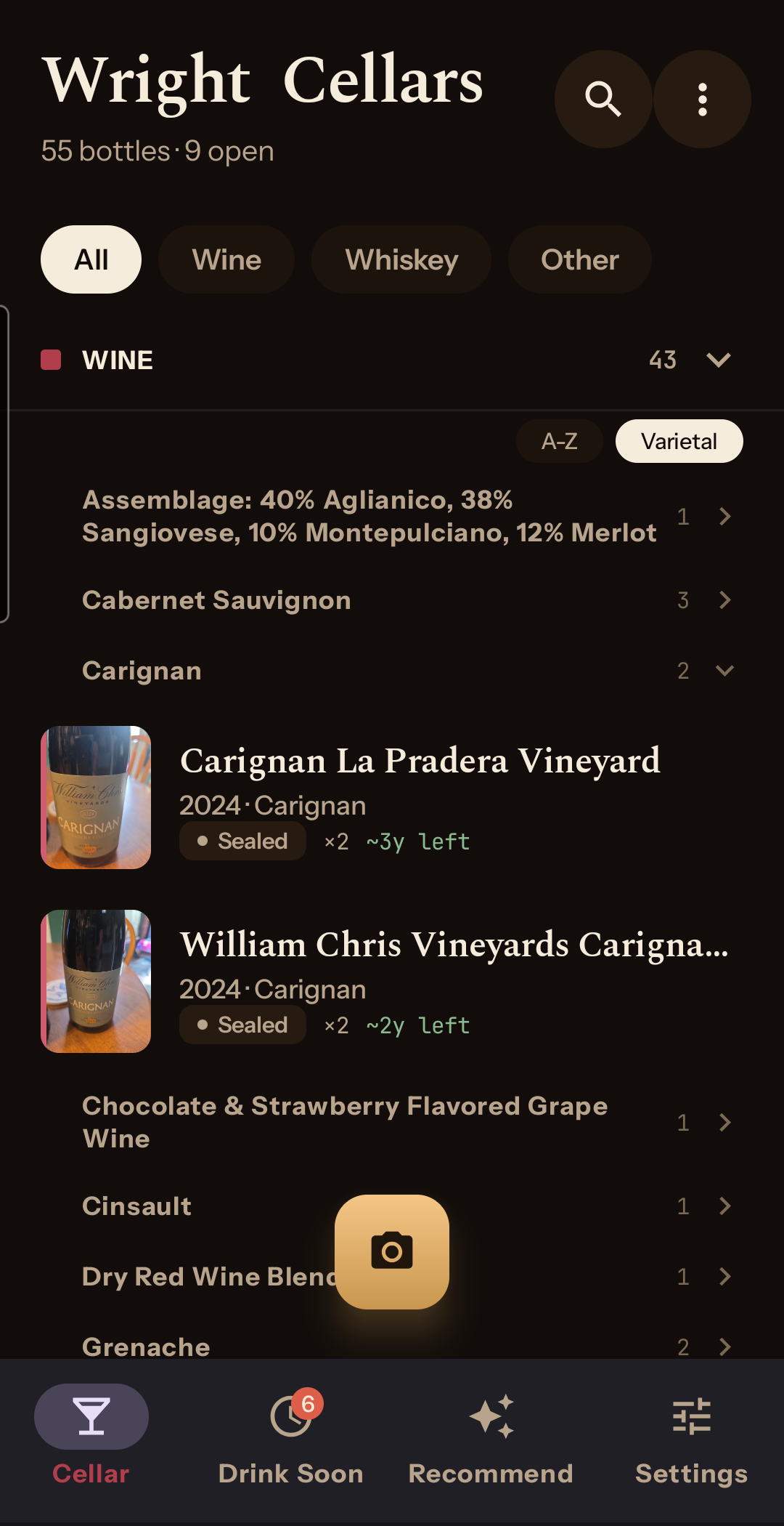 The collection screen with category-coloured bottle tiles